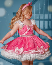 Load image into Gallery viewer, Girl wearing a pink fairytale princess dress with lace skirt, satin bows, pearl details and white ruffle trim