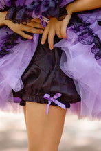 Load image into Gallery viewer, A close-up of purple and black costume skirt with layered tulle, black lace trim, and a small purple bow at the hem.