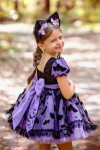Load image into Gallery viewer, Back of a Halloween party dress with oversized bow and full skirt showing bat  printed fabric.