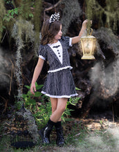 Load image into Gallery viewer, Girl wearing a black and white pinstripe Halloween play dress with tuxedo-inspired styling and full skirt.