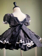 Load image into Gallery viewer, Back of a girls Halloween twirl dress with an oversized velvet bow and full layered skirt.