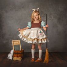 Load image into Gallery viewer, Girl wearing a vintage-inspired blue, white, and tan storybook costume dress with ruffled apron, bloomers and broom