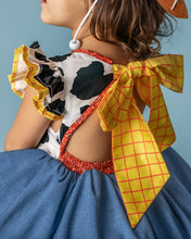 Load image into Gallery viewer, Back detail of girls cowgirl costume dress with open back, elastic waist and oversized yellow checked bow