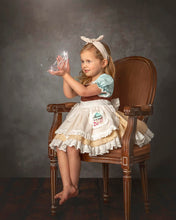 Load image into Gallery viewer, Girl wearing a blue, white, and tan fairytale dress-up costume with ruffled apron, embroidered pocket, and layered skirt