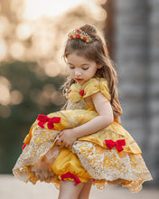 Load image into Gallery viewer, Girl wearing yellow and gold fairytale princess dress with red bows and embroidered lace skirt