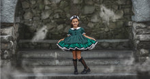 Load image into Gallery viewer, Front view of a boutique Halloween dress with green and black stripes, lace trim, and decorative fabric-covered buttons.