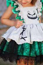 Load image into Gallery viewer, Layered skirt on a girls Halloween boutique dress with tan fabric, spiderweb overlay, green ruffles, and lace trim.