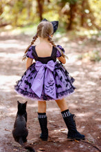 Load image into Gallery viewer, Back of a bat and cat themed Halloween party dress with oversized bow and full skirt.