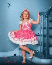 Load image into Gallery viewer, Girl wearing a pink storybook princess costume with lace skirt, satin bows, pearl waist trim and white ruffle hem