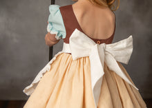 Load image into Gallery viewer, Back of girls storybook work dress showing scoop neckline, button closure and large apron sash bow