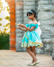 Load image into Gallery viewer, Girl wearing a turquoise Arabian princess costume dress with gold trim, full skirt and jeweled bodice