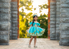 Load image into Gallery viewer, Girl wearing a turquoise storybook princess costume with full embellished skirt and gold detailing