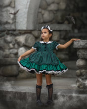 Load image into Gallery viewer, View of a boutique Halloween dress with green and black stripes, lace trim, and decorative fabric-covered buttons.
