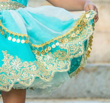 Load image into Gallery viewer, Close-up of turquoise princess dress skirt with ornate gold lace, sequins and dangling coin trim